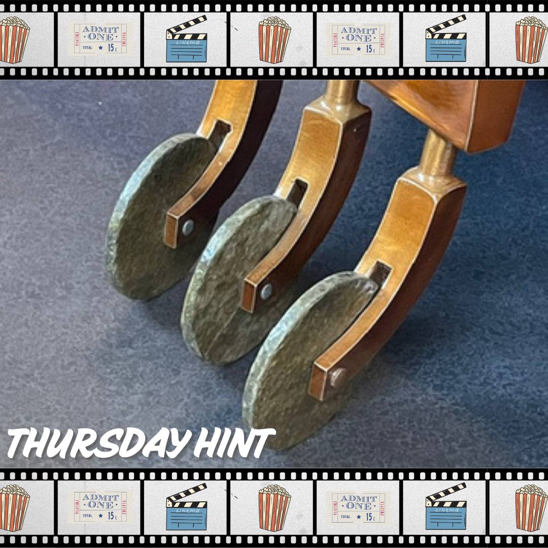 3 stone wheels attached to a wooden handle